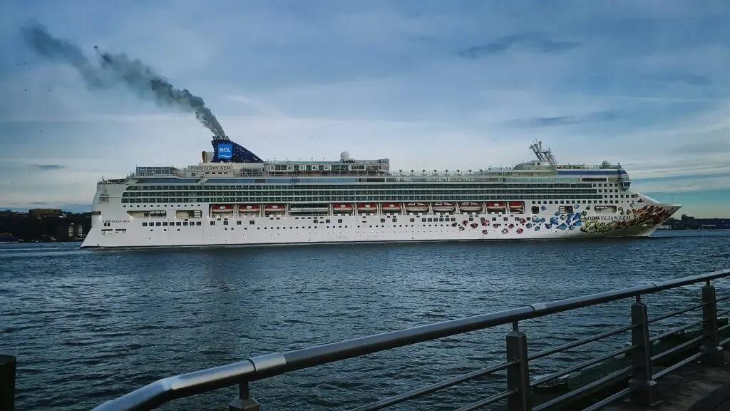 The Norwegian Gem cruise ship sailing toward the Ketchikan cruise port, providing a view of the NCL vessel passengers use to reach Ward Cove, Alaska.